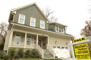 A sale sign hangs outside a new home in Northern Arlington,