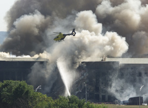 RESCUE HELICOPTER FLIES OVER AREA AT PENTAGON HIT BY AIRPLANE.