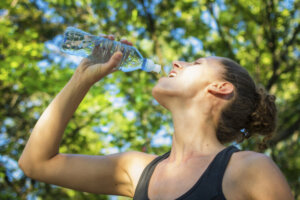 Woman drinking water on a hot day