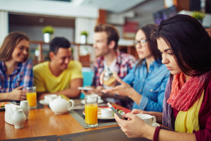 Thinkstock Teens texting at dinner
