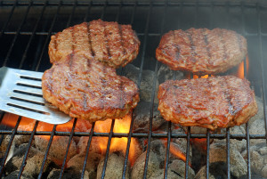 Flipping barbecue hambuger with motion blur