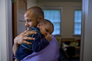 Father carrying sleeping son