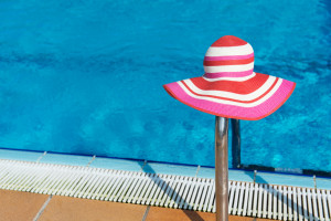 Pink sunhat at swimming pool