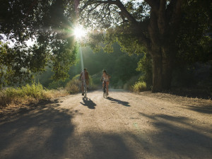 Young couple biking down dirt road