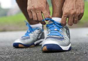 Man bending down tying his sports shoes