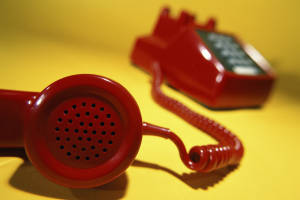 Close up of a telephone receiver off the hook