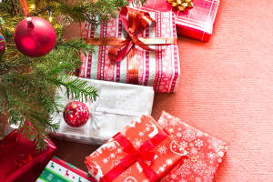 Christmas tree with gifts on red carpet