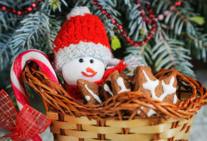 Gift basket sleigh with cookies, candy and a toy snowman