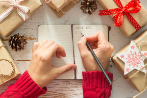 Making list of presents on wood background