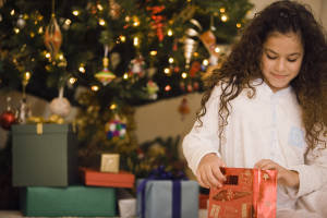Girl peeking at Christmas presents