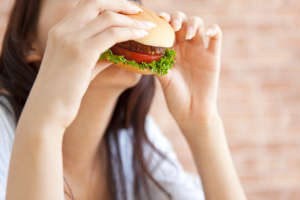 Young woman eating a hamburger