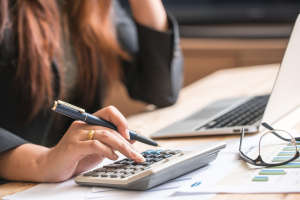 Close up of female accountant or banker making calculations. Sav