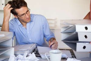 Casual businessmans workload getting bigger and bigger in the office