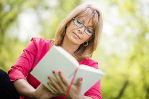 Woman reading a book in the park