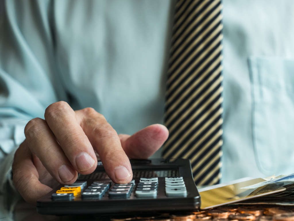 Businessman calculating profit balance