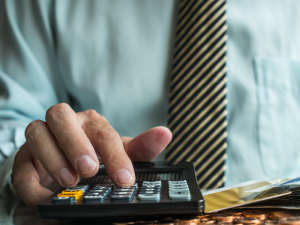 Businessman calculating profit balance