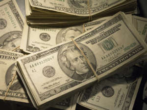 US Currency: Wads of US bills fastened with rubber bands, close up