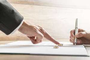 Male hand pushing a wedding ring over to female hand