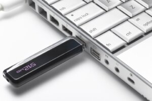 USB flash hard drive plugged into laptop, close up