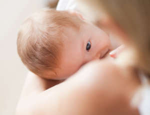 Above view of baby getting breastfed