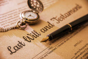 Fountain pen, pocket watch on a last will and testament.