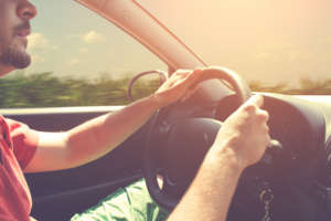 Driving and holding the steering wheel.