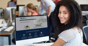 Female College Student Using Computer In Classroom