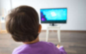 Little kid watching TV in the living room