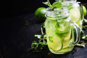 Green tea with mint and ice, black background