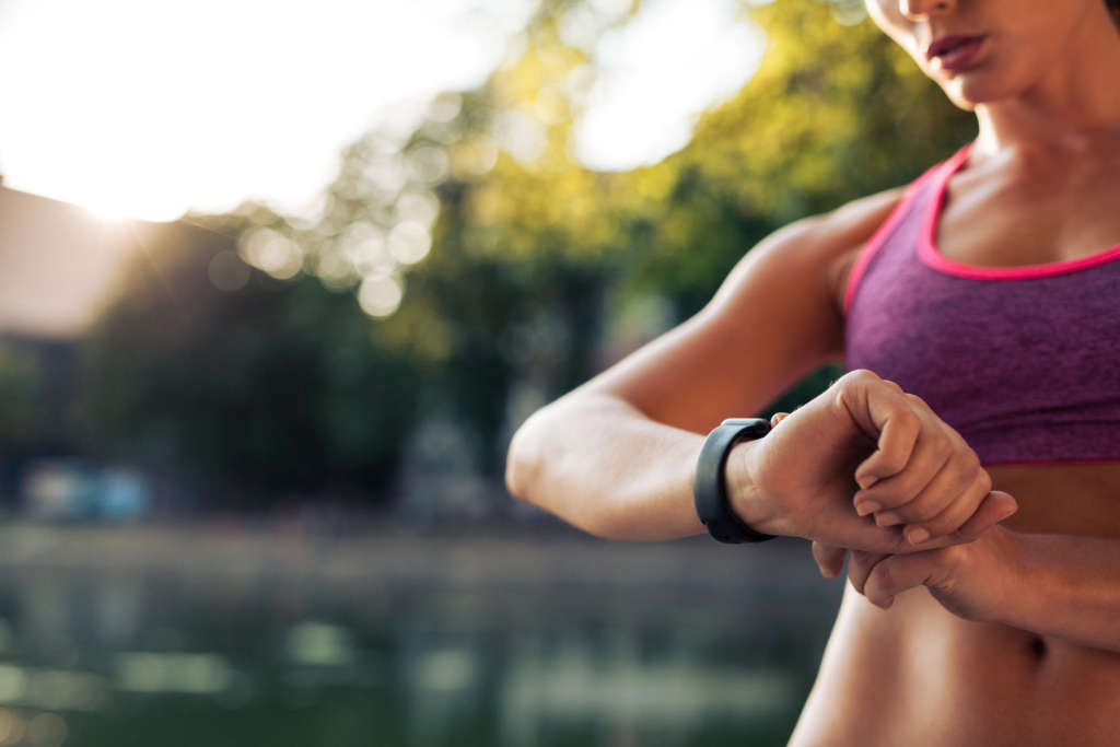 Female runner checking her smart watch
