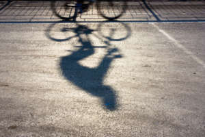 Blurry cyclist silhouette and shadow