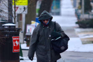 Man bundled up in the cold, windy weather