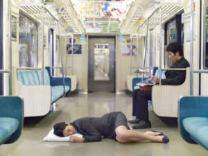 Japanese bussiness woman sleeping on a train floor
