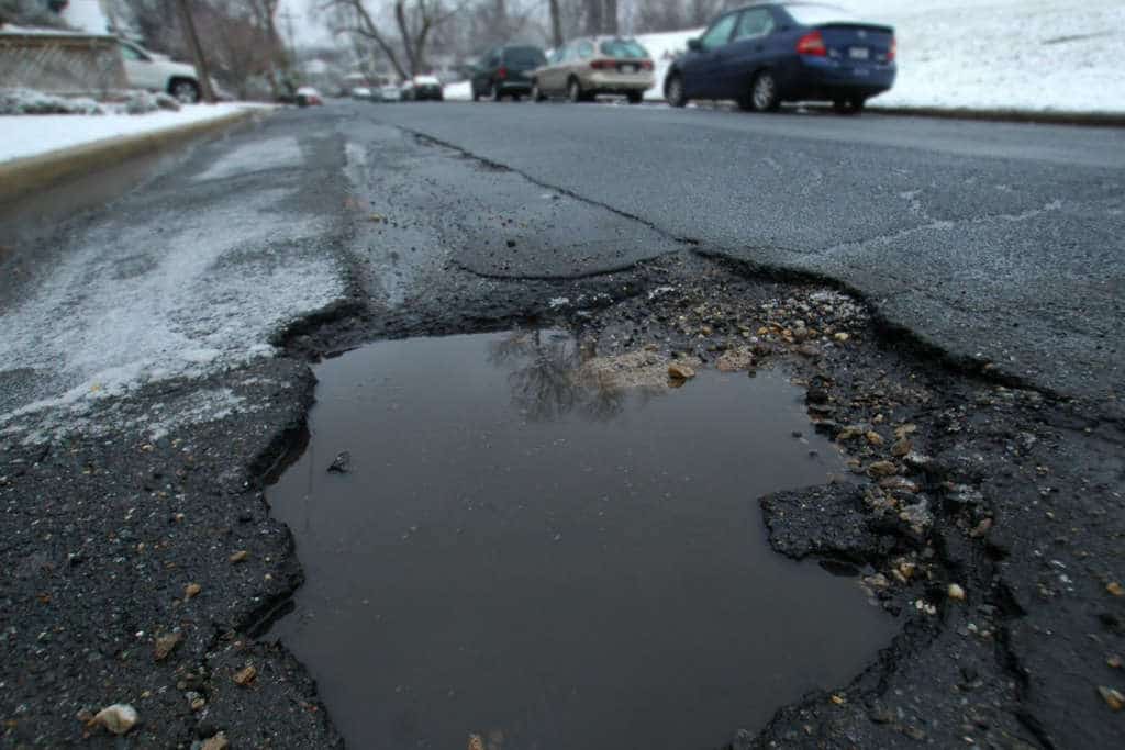 A large pothole opens up on a street in Northwest D.C. (WTOP/Dave Dildine)