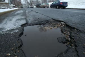 A large pothole opens up on a street in Northwest D.C. (WTOP/Dave Dildine)