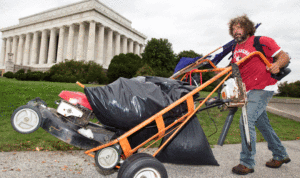 Chris Cox mows lawn beside Lincoln Memorial