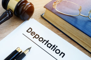 Deportation and other documents on a desk.