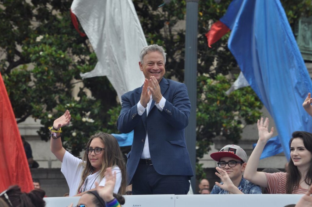Celebrity Grand Marshall, Gary Sinise, stands with children from the Snowball Express program during the 2018 National Memorial Day Parade. preview