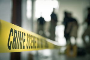 Crime scene tape with blurred forensic in cinematic tone