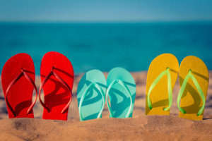 Beach flip flops on the sand