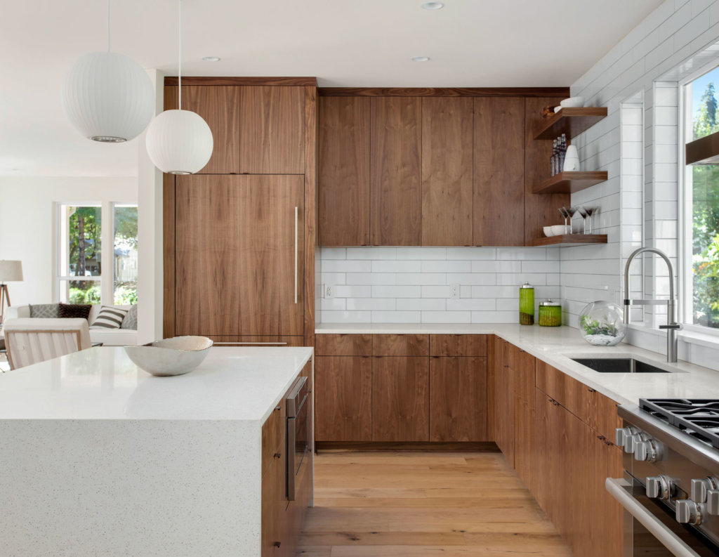 Beautiful kitchen in new luxury home with island, pendant lights, and hardwood floors