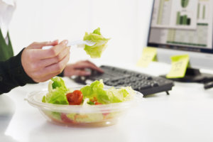 Businesswoman eating salad