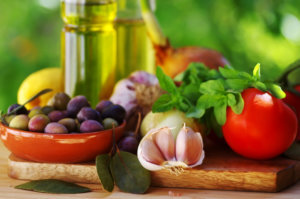 Ingredients for a mediterranean diet on green background close up