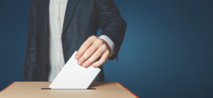 Man Voter Putting Ballot Into Voting box. Democracy Freedom Concept