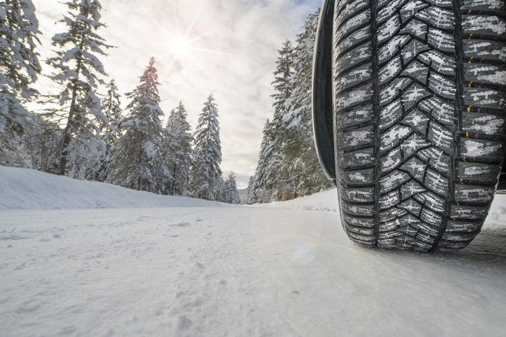 Car with winter tires on snowy road