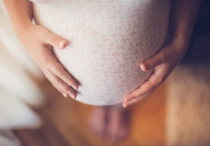 Pregnant woman touching her belly