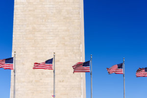 American Flags waving with Washington Monument Background, Washington DC