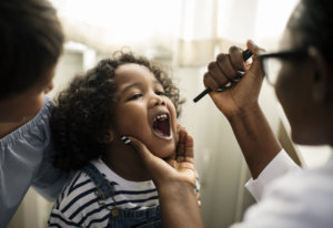 Little girl having her teeth checked