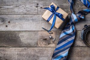 Father's day concept present, tie on rustic wood background