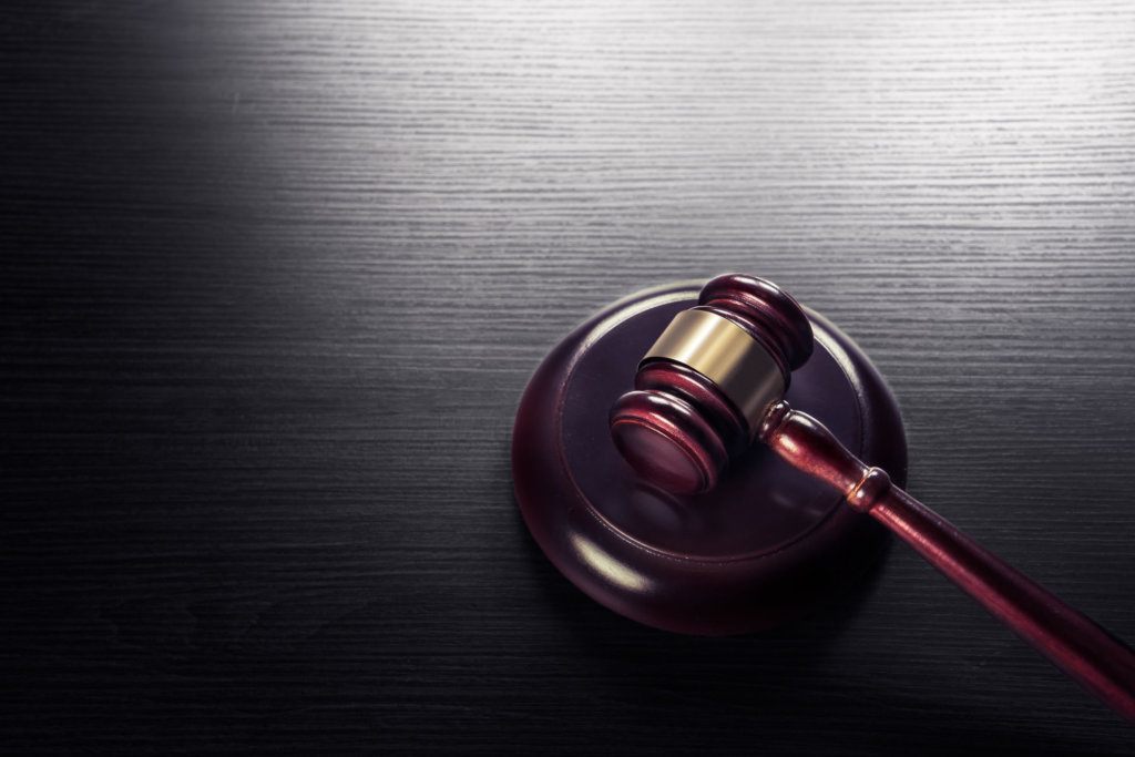 Judge gavel on a black wooden background